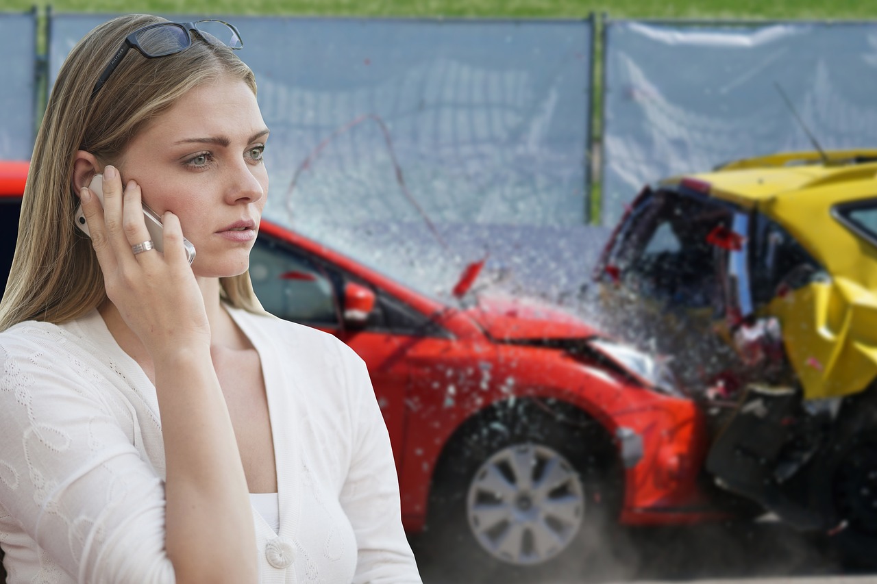 A woman near two crashed cars