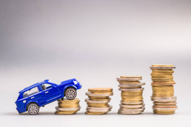A toy car going up on the increasing stack of coin
