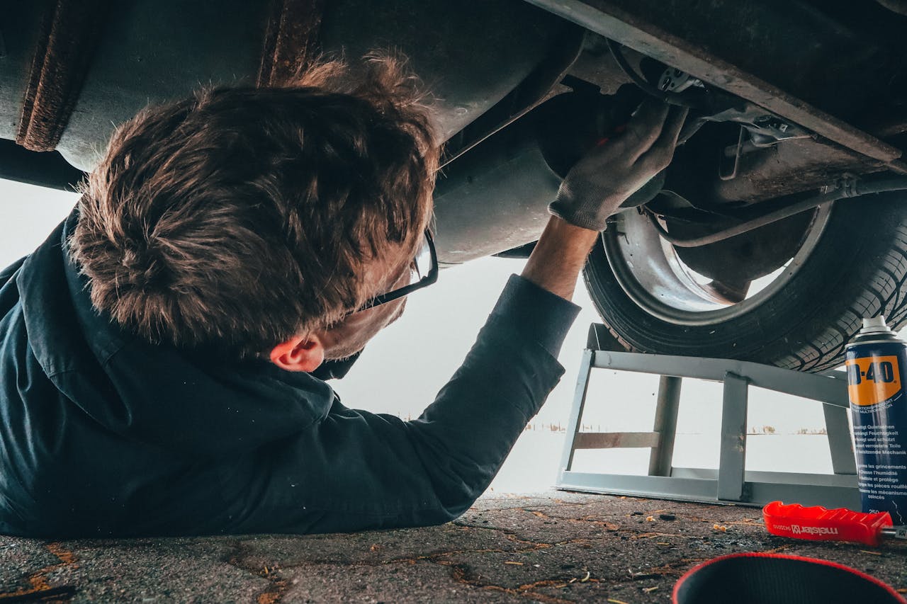 A man fixing a car in a repair shop